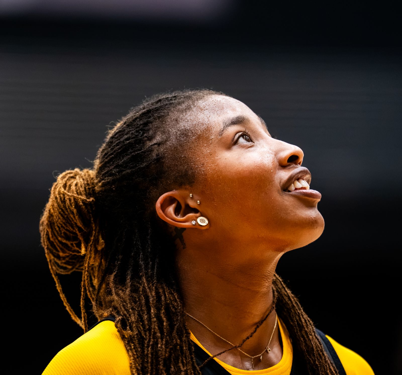 A VCU women’s basketball player smiles up at a shot during practice